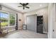 Cozy bedroom featuring a ceiling fan, murphy bed, built-in shelves, and hardwood floors at 9091 Mazette Rd, Weeki Wachee, FL 34613