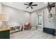 Bright bedroom featuring a ceiling fan, TV, sewing machines, desk, and natural light at 9091 Mazette Rd, Weeki Wachee, FL 34613