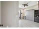 Bright bedroom featuring a ceiling fan, murphy bed, built-in shelves, and hardwood floors at 9091 Mazette Rd, Weeki Wachee, FL 34613
