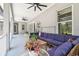 Covered patio with ceiling fans and comfortable lounge furniture at 9091 Mazette Rd, Weeki Wachee, FL 34613
