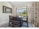 Cozy breakfast nook with a wooden table, cushioned bench, and stylish window treatments at 9091 Mazette Rd, Weeki Wachee, FL 34613