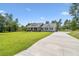 A lovely home with an extended driveway, lush lawn, and meticulously maintained landscaping at 9091 Mazette Rd, Weeki Wachee, FL 34613