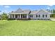 Beautiful single-story home with well-maintained landscaping, black shutters, and a charming front porch at 9091 Mazette Rd, Weeki Wachee, FL 34613