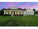 Inviting single-story home with a manicured lawn, mature landscaping, and a welcoming covered front porch at 9091 Mazette Rd, Weeki Wachee, FL 34613