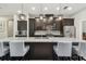 Kitchen with granite countertops, dark wood cabinets, stainless steel appliances and an island with barstool seating at 9091 Mazette Rd, Weeki Wachee, FL 34613