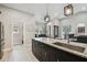 Kitchen featuring granite countertops, stainless steel appliances, a large island and tile flooring at 9091 Mazette Rd, Weeki Wachee, FL 34613