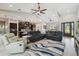 Open-concept living area flows to a kitchen, with neutral tones, modern furnishings, and a decorative ceiling fan at 9091 Mazette Rd, Weeki Wachee, FL 34613
