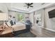 Main bedroom with ceiling fan, natural light, walk-in closet and ensuite bathroom with a soaking tub at 9091 Mazette Rd, Weeki Wachee, FL 34613