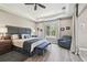 Main bedroom with ceiling fan, natural light, and grey accent wall at 9091 Mazette Rd, Weeki Wachee, FL 34613