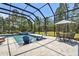 Relaxing screened pool area with a table and chairs, perfect for outdoor dining and entertaining at 9091 Mazette Rd, Weeki Wachee, FL 34613