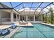 Beautiful pool with seating and a screened enclosure offering privacy at 9091 Mazette Rd, Weeki Wachee, FL 34613