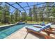 Inviting pool area with sun loungers and lush landscaping, perfect for relaxation at 9091 Mazette Rd, Weeki Wachee, FL 34613