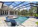 Inviting screened pool area with comfortable seating, and a hot tub for relaxing and enjoying the outdoors at 9091 Mazette Rd, Weeki Wachee, FL 34613