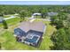 Aerial showcasing a home's private screened pool and patio area, surrounded by a lush green landscape at 9091 Mazette Rd, Weeki Wachee, FL 34613