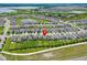 Spacious, well-maintained neighborhood with homes, green lawns, and serene water views at 9324 Rally Spring Loop, Wesley Chapel, FL 33545