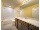Bright bathroom featuring a white subway tile shower, a large vanity, and updated fixtures at 9324 Rally Spring Loop, Wesley Chapel, FL 33545
