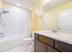 Bright bathroom featuring a subway-tiled shower and dark cabinets, creating a modern and functional space at 9324 Rally Spring Loop, Wesley Chapel, FL 33545