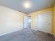 Cozy bedroom with double closets and access to a bathroom and additional rooms, featuring neutral walls and carpet at 9324 Rally Spring Loop, Wesley Chapel, FL 33545