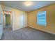 Bedroom with double closet, window with blinds for natural light, and doorway leading to other rooms at 9324 Rally Spring Loop, Wesley Chapel, FL 33545