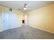 Bedroom with double closet, an ensuite bathroom, neutral walls, and carpet for a clean, comfortable aesthetic at 9324 Rally Spring Loop, Wesley Chapel, FL 33545