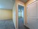 An inviting bedroom entrance with neutral walls, plush carpeting, and a ceiling fan, offering comfort and style at 9324 Rally Spring Loop, Wesley Chapel, FL 33545