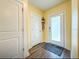 A home's entryway featuring a frosted glass door, coat rack, and wood floors at 9324 Rally Spring Loop, Wesley Chapel, FL 33545