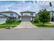 Charming two-story home with a well-manicured lawn and a two car garage at 9324 Rally Spring Loop, Wesley Chapel, FL 33545