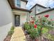 Home's entryway featuring a modern front door with a garden and plants at 9324 Rally Spring Loop, Wesley Chapel, FL 33545