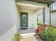 Home's entryway featuring a modern front door with a garden and plants at 9324 Rally Spring Loop, Wesley Chapel, FL 33545