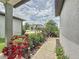 Home with a front yard, sidewalk, and lush garden with a variety of plants at 9324 Rally Spring Loop, Wesley Chapel, FL 33545