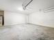 Clean, empty two car garage with concrete floors, perfect for parking vehicles and storing belongings at 9324 Rally Spring Loop, Wesley Chapel, FL 33545