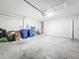 Spacious two-car garage featuring clean walls, ample storage space, and concrete flooring, ideal for parking and organization at 9324 Rally Spring Loop, Wesley Chapel, FL 33545