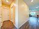 Inviting hallway with wood-look flooring leads to a well-lit living area, enhancing the home's open feel at 9324 Rally Spring Loop, Wesley Chapel, FL 33545