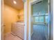 Convenient laundry room located near the bedroom at 9324 Rally Spring Loop, Wesley Chapel, FL 33545