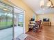 Bright living room featuring sliding glass door and an adjacent study area at 9324 Rally Spring Loop, Wesley Chapel, FL 33545
