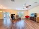 Bright living room with a ceiling fan offers ample space and sliding door access to the outdoors at 9324 Rally Spring Loop, Wesley Chapel, FL 33545