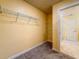 Spacious walk-in closet with wire shelving and plush carpeting, leading into an ensuite bathroom with tile flooring at 9324 Rally Spring Loop, Wesley Chapel, FL 33545