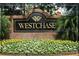 Westchase community sign surrounded by vibrant flower beds and lush greenery at 10231 Millport Dr, Tampa, FL 33626