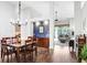 Open dining area with modern lighting, wood floors, and seamless flow to living spaces, perfect for Gathering dinners at 10231 Millport Dr, Tampa, FL 33626