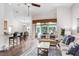 Open-concept living space featuring a kitchen with a breakfast bar and a comfortable seating area with natural light at 10231 Millport Dr, Tampa, FL 33626