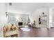 Bright living room with a fireplace, elegant furnishings, and large windows that fill the space with natural light at 10231 Millport Dr, Tampa, FL 33626