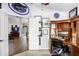 Bright office showcasing a built-in desk, sports decor, and views of the rest of the home from the interior doorway at 10231 Millport Dr, Tampa, FL 33626