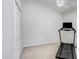 Carpeted bonus room with a vaulted ceiling, ceiling fan, treadmill, and large closet at 10231 Millport Dr, Tampa, FL 33626
