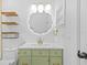 Stylish bathroom features a green vanity, gold fixtures, and modern lighting at 10701 Glen Ivy Ln, Tampa, FL 33624