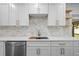 Bright kitchen with stainless steel appliances, quartz countertops, subway tile backsplash, and white cabinets at 10701 Glen Ivy Ln, Tampa, FL 33624