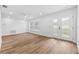 Sunlit living room with new flooring, recessed lighting, and a sliding glass door to the backyard at 10701 Glen Ivy Ln, Tampa, FL 33624
