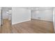 Bright and airy living room featuring new flooring, white walls, and access to a kitchen at 10701 Glen Ivy Ln, Tampa, FL 33624