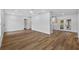 Spacious living room with modern flooring, access to the kitchen, backyard, and hallway at 10701 Glen Ivy Ln, Tampa, FL 33624