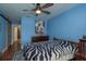 Serene bedroom with bold blue walls, wood floors, and comfortable decor at 1250 S Pinellas Ave # 214, Tarpon Springs, FL 34689