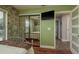 Bedroom with a full size mirror closet, adjacent to bedroom doorway and accent stone wall at 1250 S Pinellas Ave # 214, Tarpon Springs, FL 34689